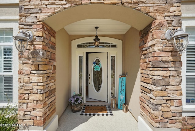 1077 Waterfall Dr, Jacksonville, FL 32225 - doorway to property with stone siding and stucco siding