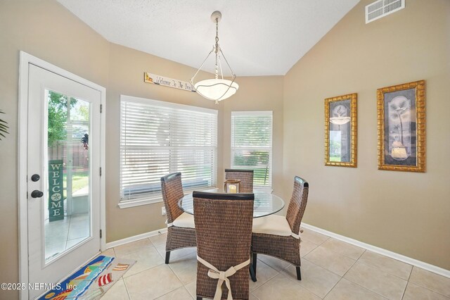 1077 Waterfall Dr, Jacksonville, FL 32225 - dining room featuring plenty of natural light, vaulted ceiling, baseboards, and light tile patterned flooring