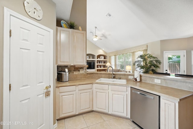 1077 Waterfall Dr, Jacksonville, FL 32225 - kitchen with stainless steel dishwasher, vaulted ceiling, a sink, healthy amount of natural light, and light countertops