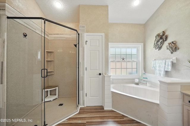 1077 Waterfall Dr, Jacksonville, FL 32225 - full bath with a bath, a stall shower, wood finished floors, vanity, and a textured ceiling