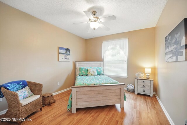 1077 Waterfall Dr, Jacksonville, FL 32225 - bedroom featuring light wood-type flooring, baseboards, a textured ceiling, and a ceiling fan
