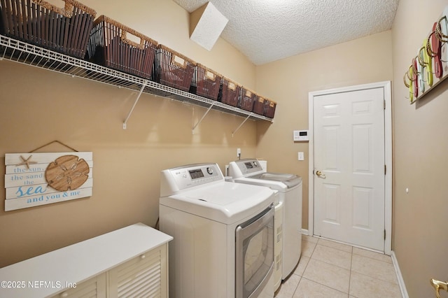 1077 Waterfall Dr, Jacksonville, FL 32225 - washroom with washer and clothes dryer, light tile patterned floors, a textured ceiling, and baseboards