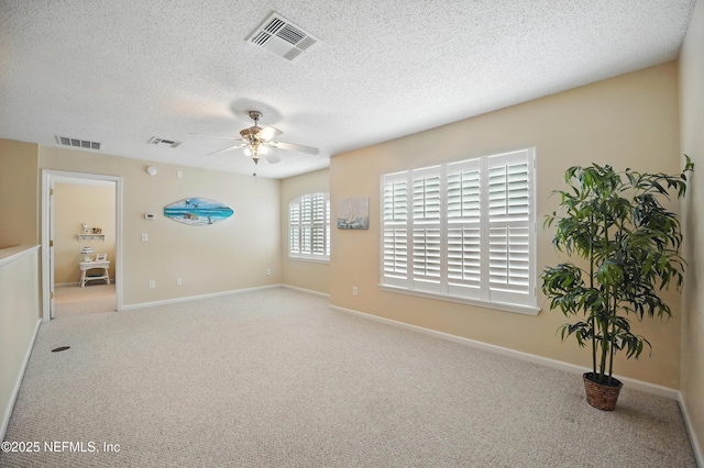 1077 Waterfall Dr, Jacksonville, FL 32225 - carpeted spare room featuring a ceiling fan, a textured ceiling, and baseboards