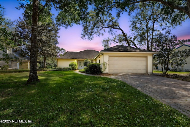 4580 Carolyn Cove Ln N, Jacksonville, FL 32258 - ranch-style home with stucco siding, a garage, decorative driveway, and a front lawn