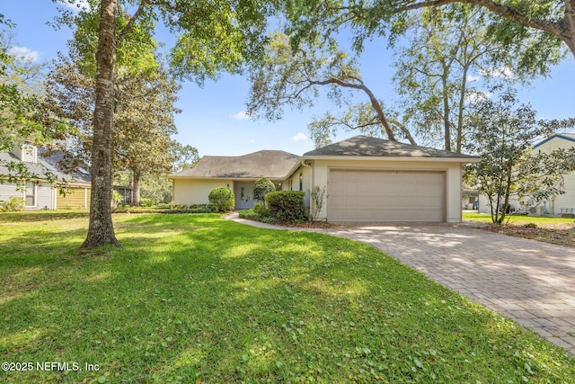 4580 Carolyn Cove Ln N, Jacksonville, FL 32258 - view of front of property with stucco siding, an attached garage, a front lawn, and decorative driveway