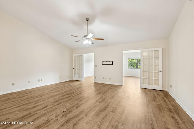 4580 Carolyn Cove Ln N, Jacksonville, FL 32258 - unfurnished living room with french doors, a ceiling fan, wood finished floors, baseboards, and vaulted ceiling