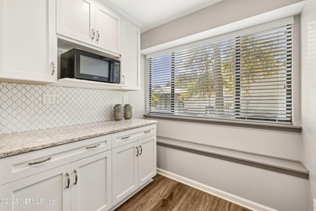 4580 Carolyn Cove Ln N, Jacksonville, FL 32258 - kitchen featuring black microwave, white cabinetry, dark wood-style flooring, tasteful backsplash, and baseboards
