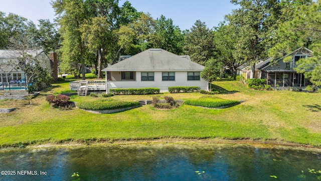 4580 Carolyn Cove Ln N, Jacksonville, FL 32258 - rear view of property featuring a water view, a sunroom, a yard, and stucco siding