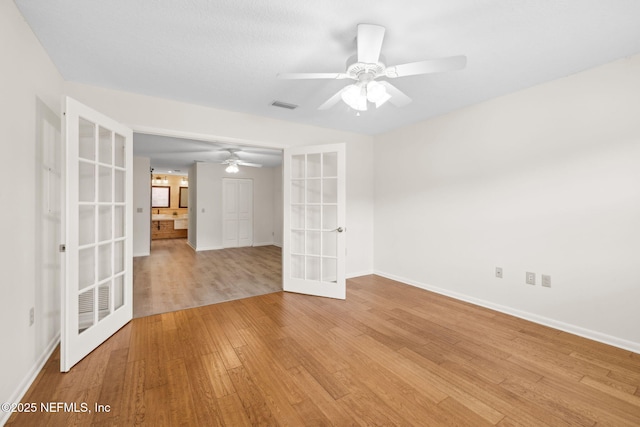 4580 Carolyn Cove Ln N, Jacksonville, FL 32258 - spare room with french doors, baseboards, light wood-type flooring, and a ceiling fan