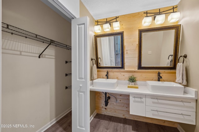 4580 Carolyn Cove Ln N, Jacksonville, FL 32258 - full bathroom featuring wooden walls, wood finished floors, double vanity, and baseboards