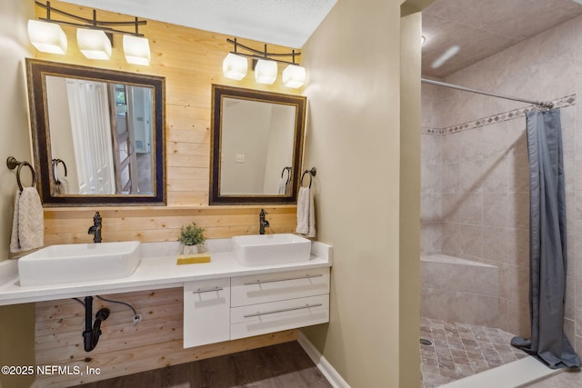 4580 Carolyn Cove Ln N, Jacksonville, FL 32258 - full bath featuring tiled shower, double vanity, wood walls, and wood finished floors