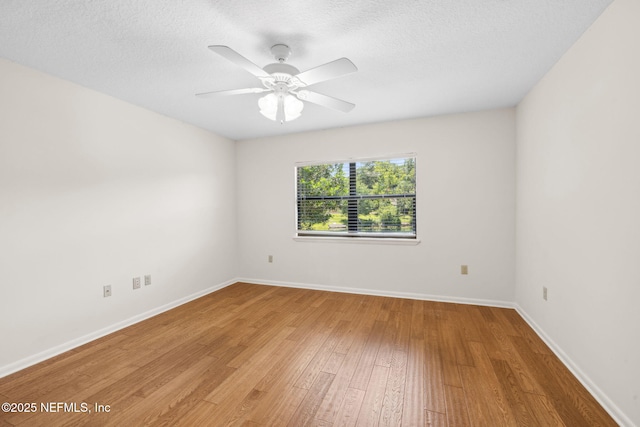 4580 Carolyn Cove Ln N, Jacksonville, FL 32258 - unfurnished room featuring light wood-style floors, baseboards, a ceiling fan, and a textured ceiling