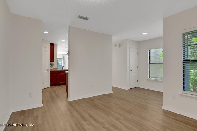 274 Syrah Way, Saint Augustine, FL 32084 - empty room with light wood finished floors, plenty of natural light, baseboards, and recessed lighting
