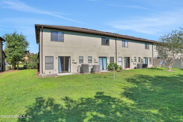 274 Syrah Way, Saint Augustine, FL 32084 - rear view of property with central AC unit, a yard, and stucco siding