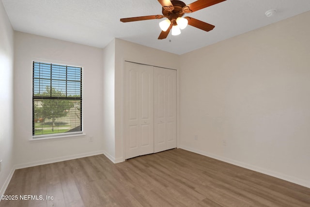 274 Syrah Way, Saint Augustine, FL 32084 - unfurnished bedroom with light wood finished floors, a closet, baseboards, and ceiling fan