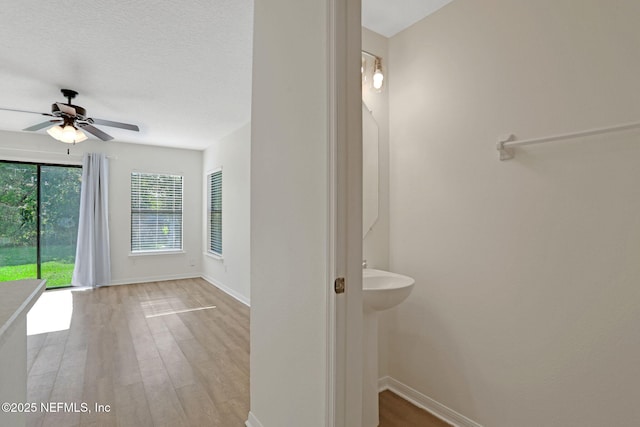 274 Syrah Way, Saint Augustine, FL 32084 - bathroom featuring baseboards, ceiling fan, and wood finished floors