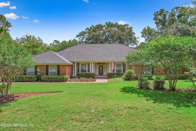 8127 Middle Fork Ln, Jacksonville, FL 32256 - ranch-style home featuring a front yard, covered porch, and brick siding