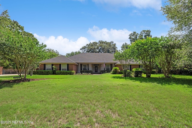 8127 Middle Fork Ln, Jacksonville, FL 32256 - ranch-style home featuring a front yard and brick siding