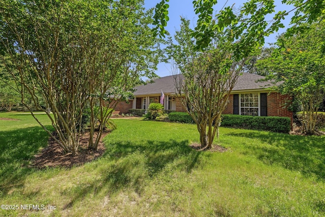 8127 Middle Fork Ln, Jacksonville, FL 32256 - ranch-style house with a front lawn, brick siding, and roof with shingles