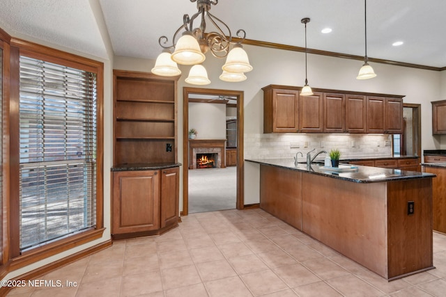 8127 Middle Fork Ln, Jacksonville, FL 32256 - kitchen featuring a peninsula, healthy amount of natural light, decorative backsplash, a warm lit fireplace, and crown molding