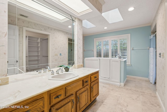 8127 Middle Fork Ln, Jacksonville, FL 32256 - full bathroom with a skylight, crown molding, vanity, baseboards, and a shower with shower curtain