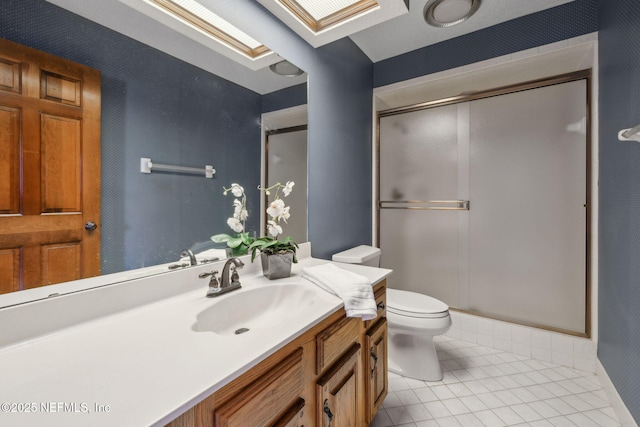 8127 Middle Fork Ln, Jacksonville, FL 32256 - bathroom with a skylight, tile patterned floors, a shower stall, vanity, and toilet