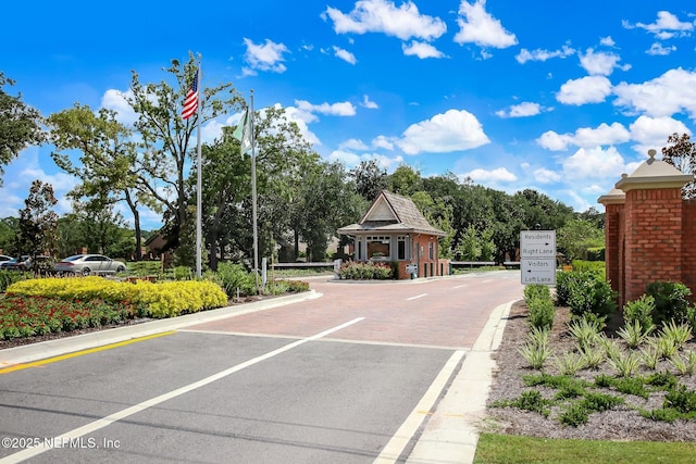 8127 Middle Fork Ln, Jacksonville, FL 32256 - view of asphalt road with curbs and a gated entry