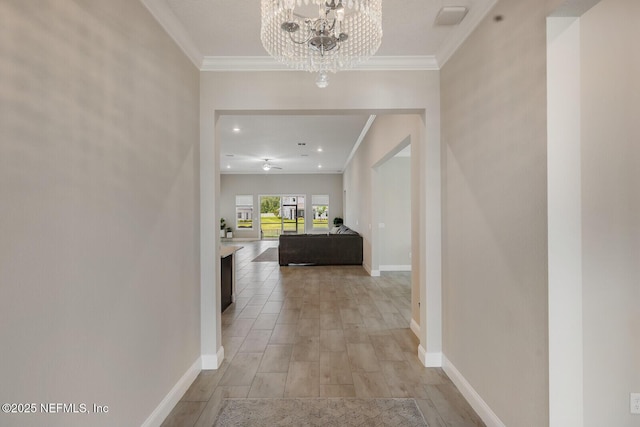70 Pavo Cir, Saint Johns, FL 32259 - hall featuring ornamental molding, a chandelier, light wood-style flooring, and baseboards