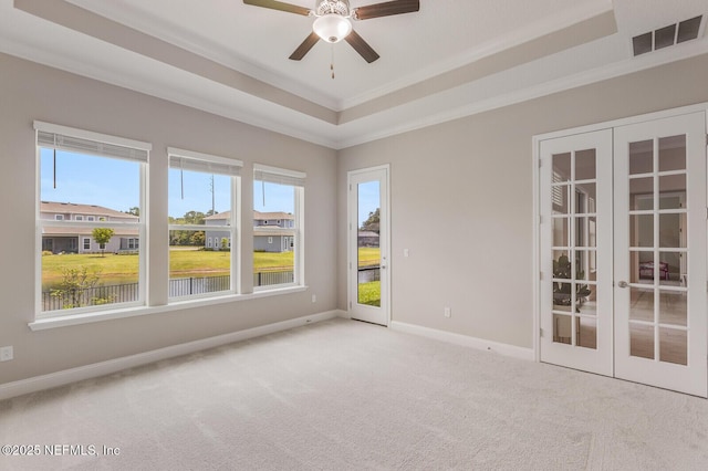 70 Pavo Cir, Saint Johns, FL 32259 - spare room featuring french doors, a raised ceiling, carpet, baseboards, and crown molding