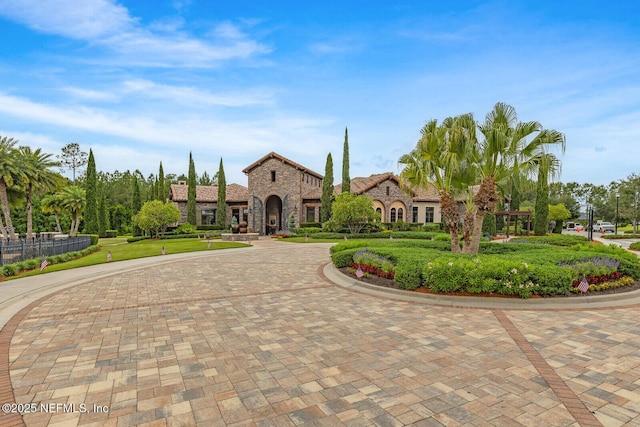 70 Pavo Cir, Saint Johns, FL 32259 - view of front of property featuring stone siding, curved driveway, and a front lawn