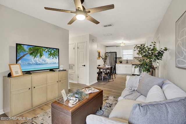 521 Talbot Ave, Jacksonville, FL 32205 - living area with light wood-type flooring, a ceiling fan, and baseboards