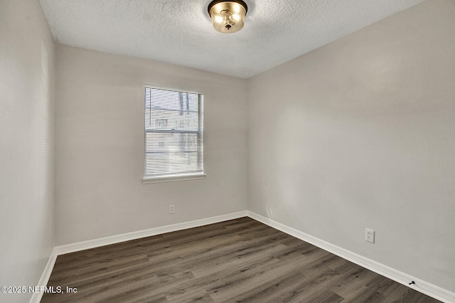 521 Talbot Ave, Jacksonville, FL 32205 - empty room with dark wood-style flooring, a textured ceiling, and baseboards
