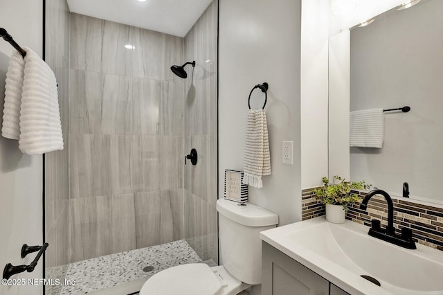 521 Talbot Ave, Jacksonville, FL 32205 - full bathroom with a tile shower, decorative backsplash, toilet, and vanity