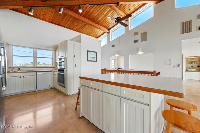 2605 S Ponte Vedra Blvd, Ponte Vedra Beach, FL 32082 - kitchen with track lighting, white dishwasher, wood ceiling with exposed beams, high vaulted ceiling, and ceiling fan