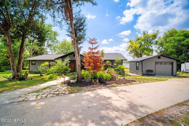 153 Jaffa Rd, Crescent City, FL 32112 - view of front facade with concrete driveway, an outdoor structure, and a garage