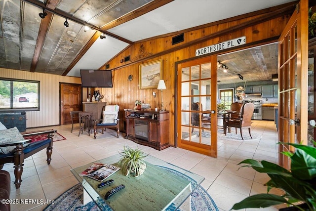 153 Jaffa Rd, Crescent City, FL 32112 - living room featuring lofted ceiling, healthy amount of natural light, wood walls, track lighting, and tile patterned floors