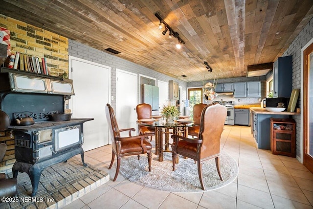 153 Jaffa Rd, Crescent City, FL 32112 - dining room with wood ceiling, rail lighting, light tile patterned floors, and brick wall