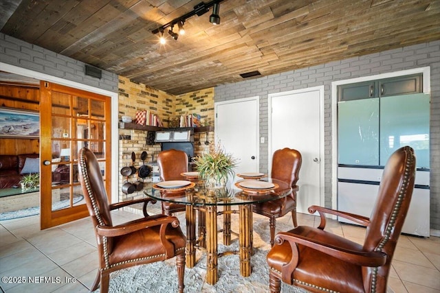 153 Jaffa Rd, Crescent City, FL 32112 - dining area featuring rail lighting, brick wall, french doors, light tile patterned flooring, and wood ceiling