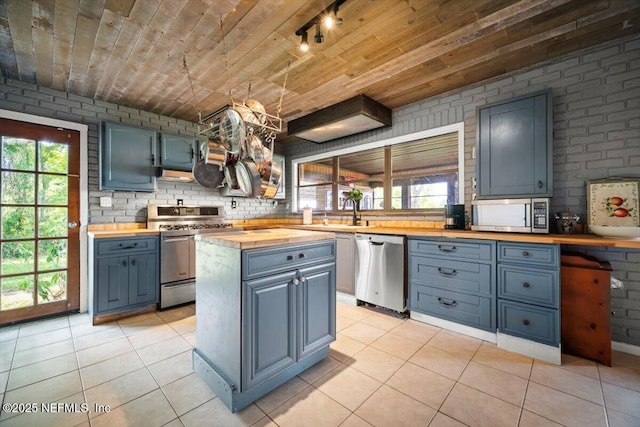 153 Jaffa Rd, Crescent City, FL 32112 - kitchen featuring butcher block counters, stainless steel appliances, healthy amount of natural light, wood ceiling, and light tile patterned flooring