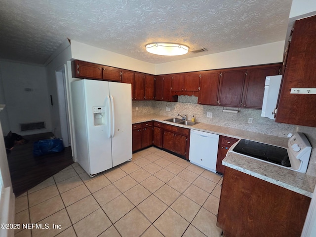 2 Bonita Dr, Ponte Vedra Beach, FL 32082 - kitchen with white appliances, light tile patterned flooring, light countertops, a textured ceiling, and backsplash