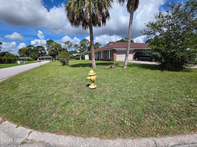 2 Bonita Dr, Ponte Vedra Beach, FL 32082 - ranch-style house with an attached garage, driveway, a front yard, and brick siding