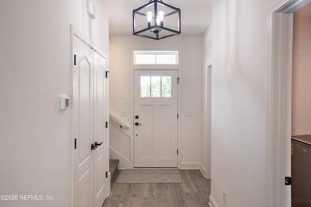 15466 Bullock Bluff Rd, Bryceville, FL 32009 - entryway featuring light wood-type flooring, baseboards, and a chandelier