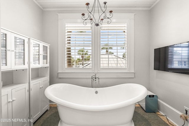 102 Palm Pl, Neptune Beach, FL 32266 - full bathroom featuring a freestanding bath, a chandelier, ornamental molding, and tile patterned floors
