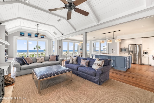 102 Palm Pl, Neptune Beach, FL 32266 - living area with decorative columns, a ceiling fan, light wood-style floors, and a water view