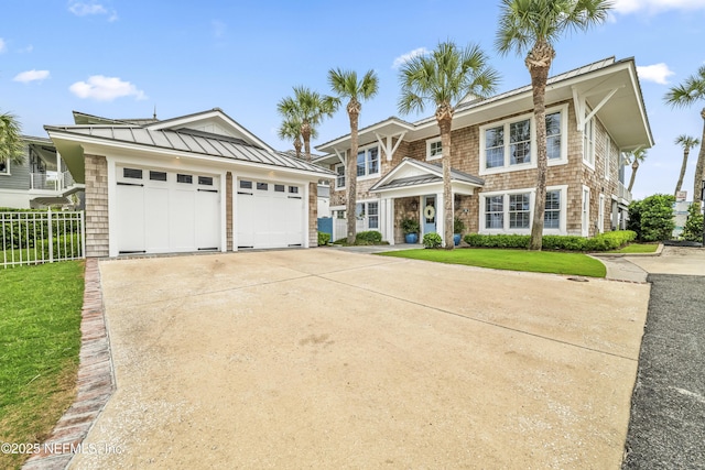102 Palm Pl, Neptune Beach, FL 32266 - view of front facade with a standing seam roof, driveway, and metal roof