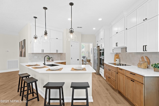 1008 Durbin Parke Dr, Saint Johns, FL 32259 - kitchen featuring a sink, light wood-style flooring, tasteful backsplash, a breakfast bar area, and recessed lighting