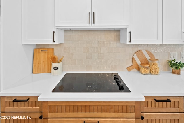 1008 Durbin Parke Dr, Saint Johns, FL 32259 - kitchen featuring black electric cooktop, white cabinets, and light countertops