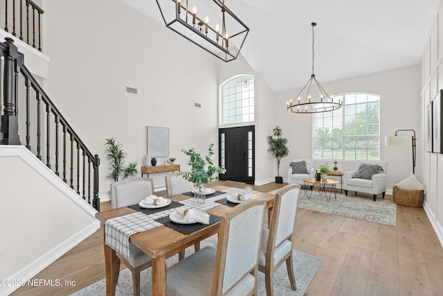 1008 Durbin Parke Dr, Saint Johns, FL 32259 - dining room with a chandelier, high vaulted ceiling, light wood-type flooring, and baseboards