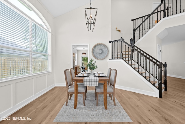 1008 Durbin Parke Dr, Saint Johns, FL 32259 - dining room featuring wood finished floors, stairway, and high vaulted ceiling