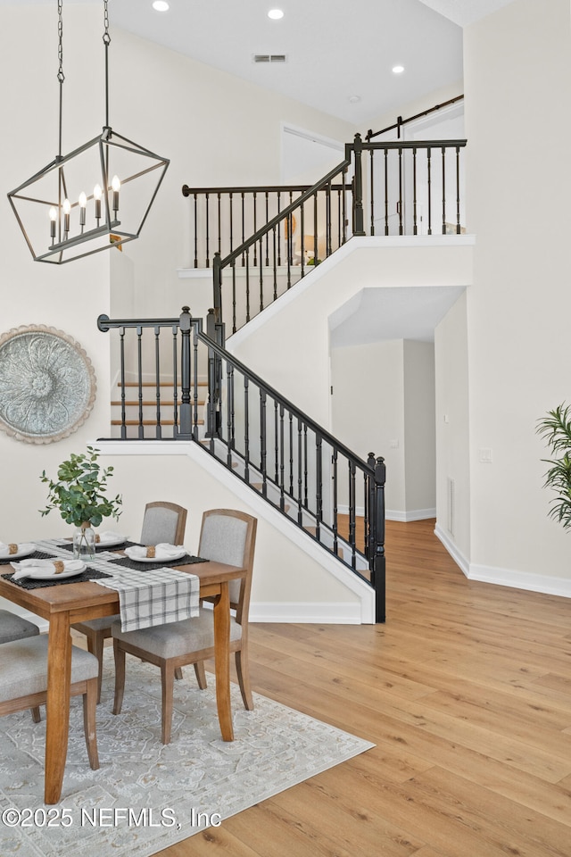 1008 Durbin Parke Dr, Saint Johns, FL 32259 - staircase with a chandelier, wood finished floors, recessed lighting, baseboards, and a towering ceiling